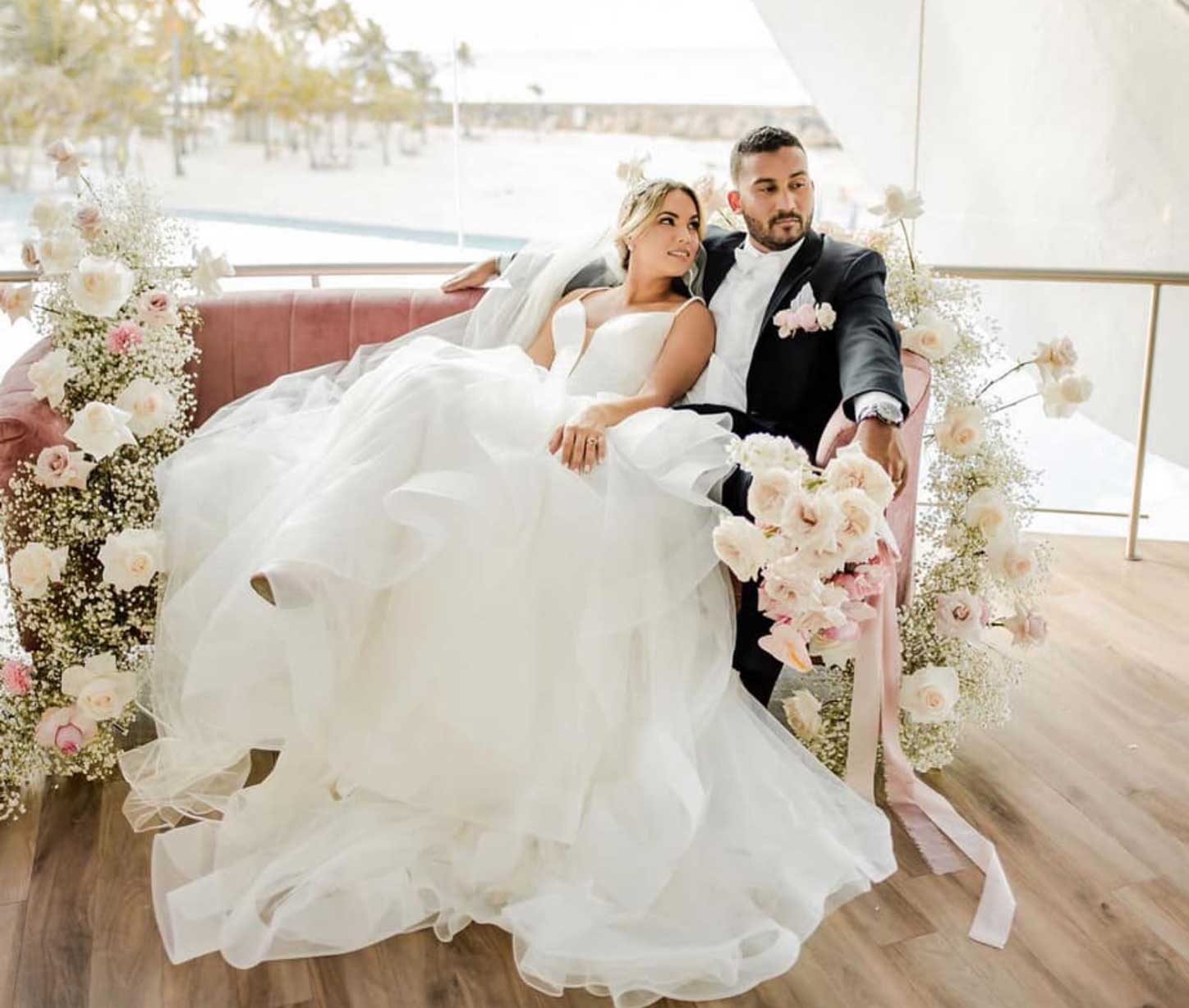 Сouple wearing a white gown and a black suit