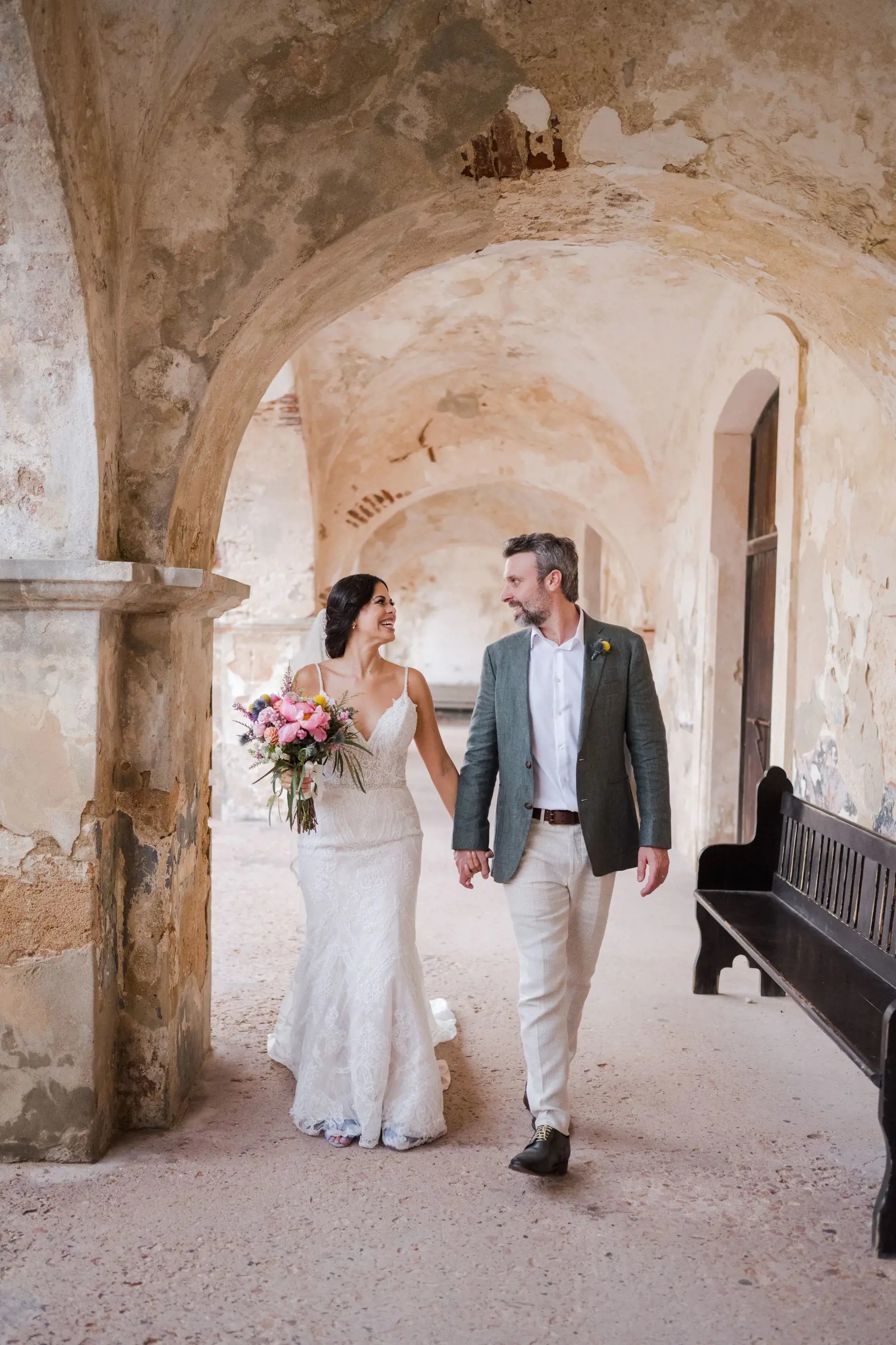Сouple wearing a white gown and a white suit